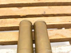 Vintage brass binoculars on rustic wooden table, showcasing craftsmanship and classic design.