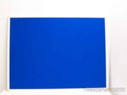 Vibrant blue notice board with light gray frame, ideal for organization and creativity.