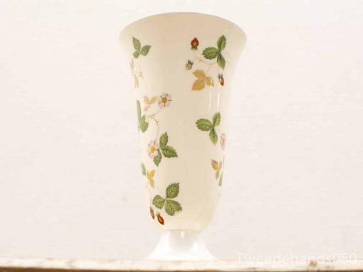 Delicate porcelain vase with pink floral motifs and green leaves, perfect for elegant decor.