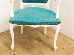 Turquoise vintage chair with elegant wood frame, perfect for adding style to any interior.