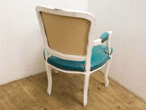 Vintage turquoise chair with a distressed white frame and elegant curved design.