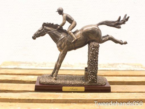 Dynamic bronze sculpture of horse and rider, titled Arkle, celebrating equestrian excellence.