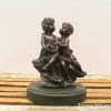 Bronze sculpture of joyful children celebrating innocence and friendship in playful interaction.