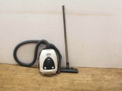 Modern white canister vacuum cleaner with flexible hose, ideal for versatile home cleaning tasks.