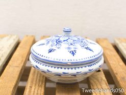 Elegant blue and white ceramic bowl with lid, featuring intricate floral patterns.