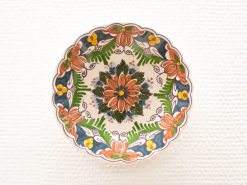 Vibrant floral ceramic bowl, intricately designed with warm colors, perfect for decoration or serving.