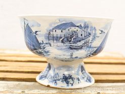 Intricate blue-and-white ceramic bowl showcasing rural life and community scenes, perfect for collection.