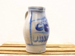 Elegant hand-painted ceramic jug with blue designs, perfect for decoration or kitchen use.