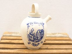 Delft ceramic jug featuring hand-painted monk meditation design, perfect for art and pottery collectors.