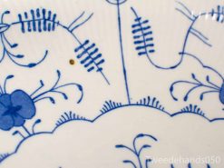 Elegant ceramic plate featuring intricate blue floral designs on a white background.