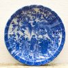 Beautiful blue-and-white ceramic plate showcasing traditional Chinese figures and nature motifs.