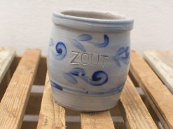 Elegant light blue ceramic pot with ZOUT and rustic wood base for stylish decor.