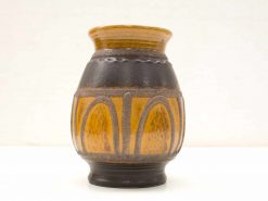 Artisan black and amber ceramic vase with elegant arches and contrasting textures.