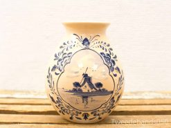 Elegant Delftware vase featuring a serene windmill landscape and floral designs in blue and white.