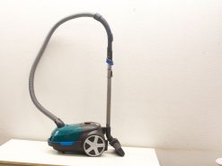 Stylish black and turquoise compact vacuum with telescoping wand for versatile cleaning.