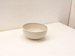 Elegant creamy beige ceramic bowl with subtle blue lines for modern or rustic settings.