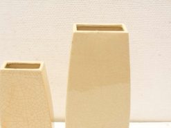 Elegant cream ceramic vases with crackled finish, ideal for modern home decor.