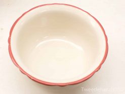 Elegant ceramic bowl with glossy cream interior and scalloped red rim, perfect for any occasion.