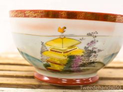 Vintage decorative bowl featuring pagoda and floral designs in vibrant colors.