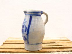 Hand-painted gray ceramic jug with blue patterns, showcasing artisan craftsmanship and rustic charm.