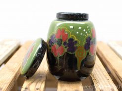 Vibrant green decorative jar with floral patterns, perfect for storage or display.