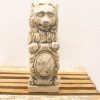 Vintage lion statue with shield, showcasing playful expression and intricate craftsmanship.