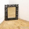 Elegant black mirror with ornate frame, perfect for adding vintage charm to any space.