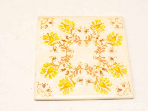 Elegant floral tile with vibrant yellow blooms and soft pink accents, perfect for home decor.