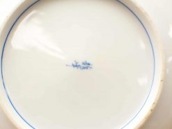 Elegant antique blue porcelain plate with white background and distinctive craftsmanship.