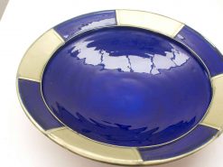 Elegant deep blue ceramic bowl with unique contrasting rim, perfect for display or serving.