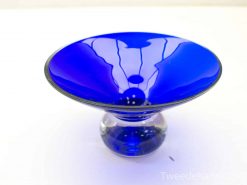 Elegant cobalt blue glass bowl, perfect for vintage decor and captivating light reflections.