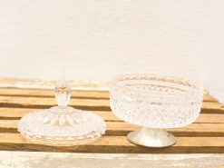 Elegant vintage glass compote with lid, perfect for serving desserts or decorative display.