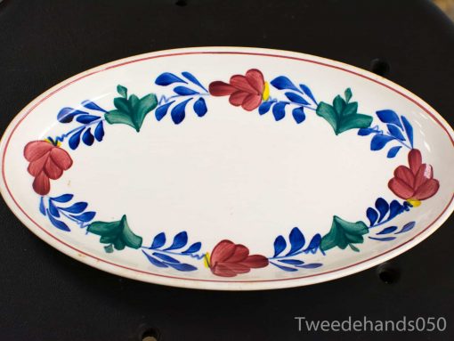 Elegant hand-painted oval platter with vibrant floral design, perfect for stylish dining presentations.