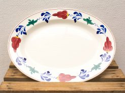 Elegant oval serving platter with vibrant floral design, perfect for dining and special occasions.