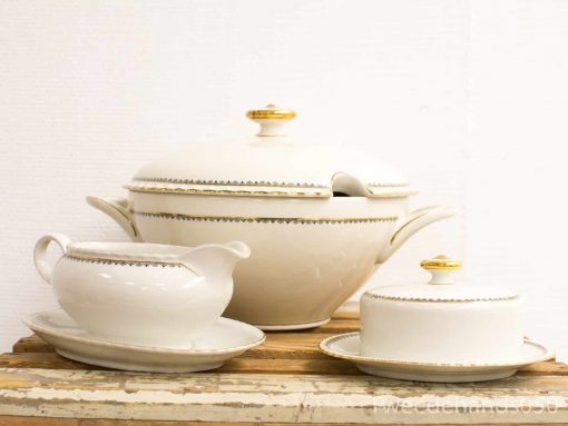 Elegant vintage porcelain dinnerware set with gold accents for luxurious dining experiences.