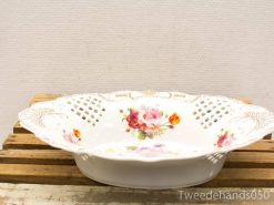 Elegant porcelain dish with floral patterns and gold accents, perfect for dining or decoration.