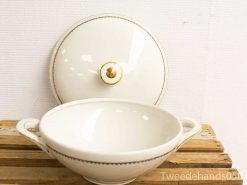 Elegant porcelain serving dish with gold accents and matching lid, perfect for any occasion.