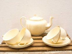 Elegant ivory tea set with gold trim, perfect for cozy tea parties and gatherings.