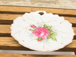 Elegant vintage porcelain plate with rose design, perfect for decor or wall display.