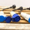 High-quality blue and white connectors for reliable high-voltage electrical connections outdoors.