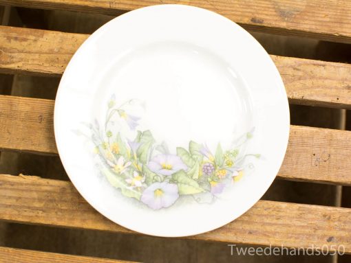 Elegant white porcelain flower plate with pastel design, perfect for any dining occasion.