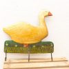 Charming yellow wooden duck with hooks, perfect for keys and whimsical home decor.