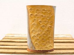 Artisan ceramic vase with fish motif in earthy tones, perfect for decoration or floral displays.