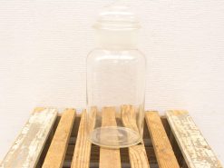 Vintage glass jar with opaque lid, ideal for storage or decorative use in your home.