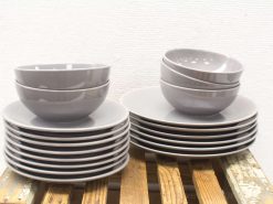 Elegant gray dishware set featuring stacked plates and bowls in a modern vintage style.