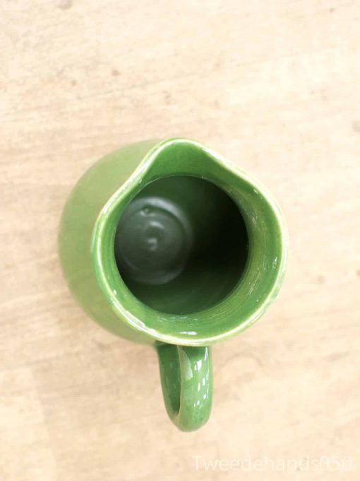 Elegant handmade green ceramic jug with a glossy finish and sturdy handle for decorative use.