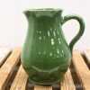 Elegant green vintage pitcher for a charming kitchen or dining display, combining functionality and style.