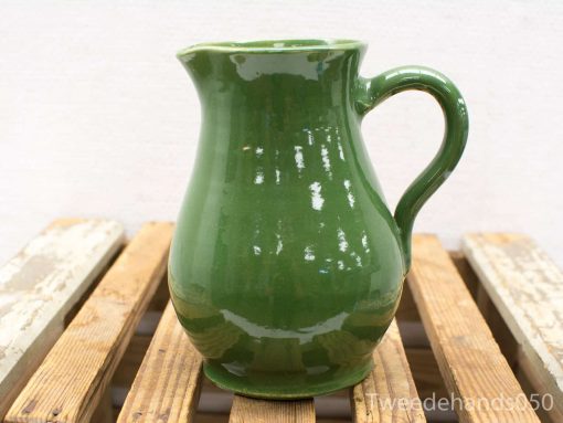 Elegant green vintage pitcher for a charming kitchen or dining display, combining functionality and style.