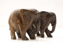 Handcrafted wooden elephant sculptures symbolizing friendship and artistry in dark, polished wood.