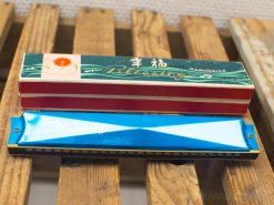 Vintage blue harmonica with a decorative red case, perfect for music lovers and collectors.